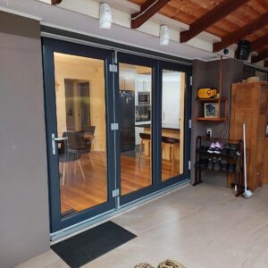 Bi-folding-door-in-Anthracite-grey-external-and-white-internal-installed-with-a-UPVC-frame-Low-E-energy-efficient-sound-efficient-scaled-1