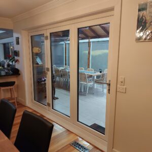 Bi-folding-door-with-white-internal-installed-with-a-UPVC-frame-Low-E-energy-efficient-sound-efficient-scaled-1